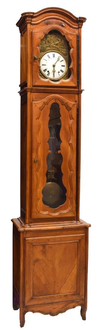 FRENCH STANDING TALL CASE MORBIER CLOCK: French standing case Morbier clock, 19th c., having time and strike movement, brass dial with enameled roman numerals, scene in relief of rural worker with shafts of wheat and windmill, behind glass p