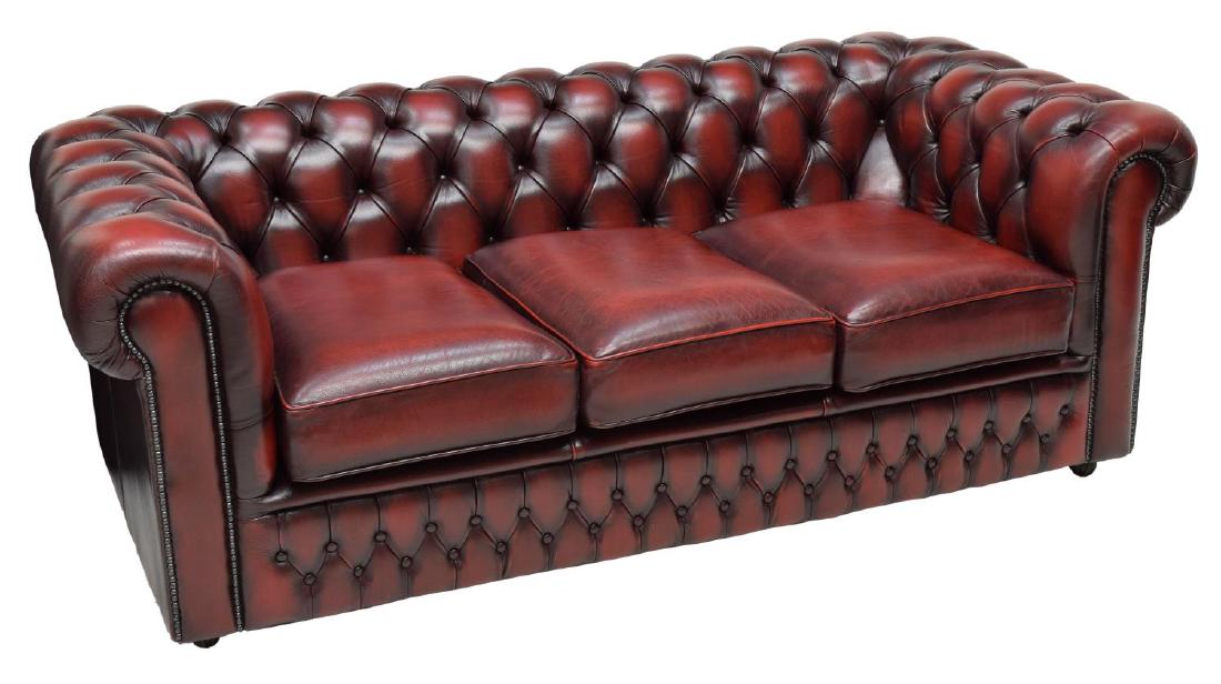 CHESTERFIELD MAROON BUTTONED LEATHER SOFA: Chesterfield maroon buttoned leather sofa, 1990's, three removable cushions, rising on castors, 27"h, 60"w, 35"d Start Price: $450.00