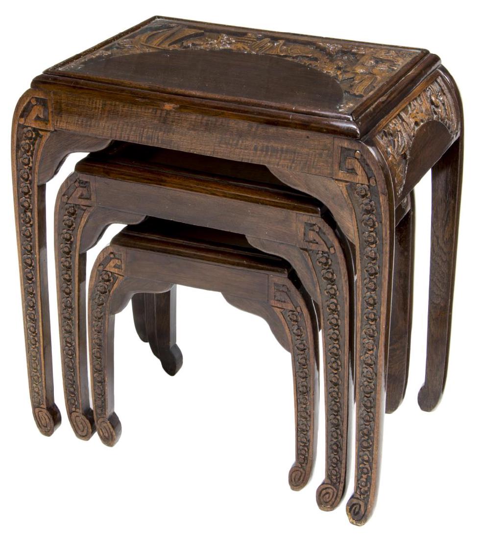 (3) ASIAN CARVED DARK WOOD NESTING TABLES: (lot of 3) Carved dark wood nesting tables, c. 1960, top features carved Asian port scene with ship, pagoda, and figures under glass, some wear, 25" h, 22.5" w, 14" d