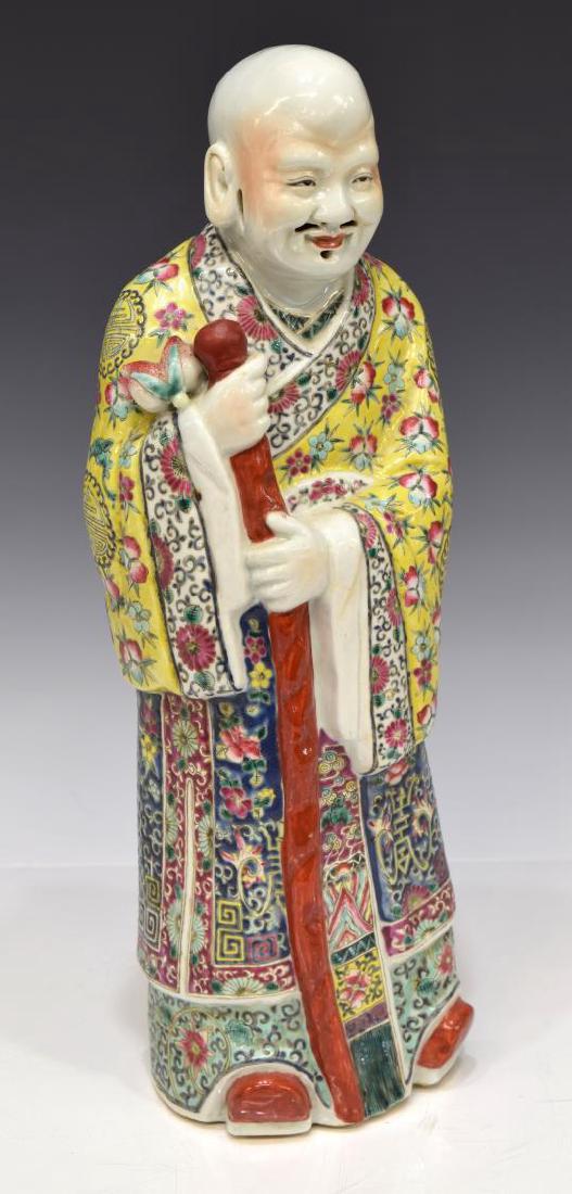 CHINESE PORCELAIN FIGURE, MAN WITH STAFF, 17"H: Chinese porcelain figure, a man dressed in a colorful robe holding a staff and lotus flower, 17.5"h, 5.25"w, 4.75"d, 5.25lbs Start Price: $80.00