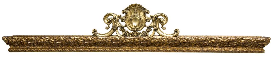 CONTINENTAL GILTWOOD CARVED CURTAIN VALENCE: Continental giltwood cornice valence, 20th c., pierced rocaille medallion crest over stepped cornice ornamented with carved scrolling foliates, some gilt loss, spotting, 13.75"h, 72.5"w, 10.75"d Start