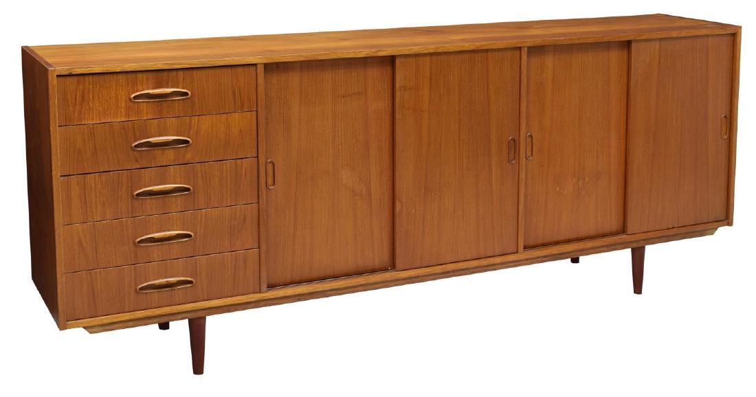 DANISH MID-CENTURY MODERN TEAKWOOD SIDEBOARD: Danish mid-century modern teakwood sideboard, c. 1950s, having rectangular case, fitted with sliding doors, opening to shelving, and five stacked drawers on far left side, all rising on tapered legs, 
