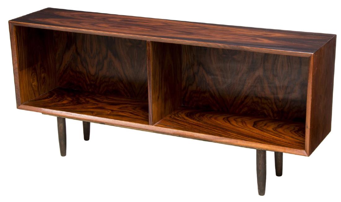 DANISH MID-CENTURY MODERN LOW ROSEWOOD BOOKCASE: Danish mid-century modern low rosewood bookcase, c. 1960s, having rectangular case, shelving divided vertically at center of case, with beveled front edge, rising on tapered legs, approx 24"h, 53.25"w