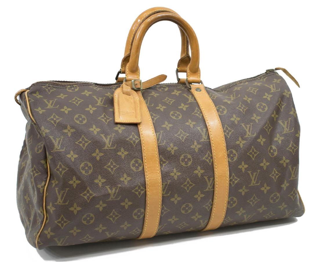 LOUIS VUITTON 'KEEPALL 45' MONOGRAM CANVAS DUFFLE: Louis Vuitton "KeepAll 45" traveling duffle bag in monogram canvas, having leather handles, piping and trim, gold tone hardware, zip top opens to brown canvas lined interior, retaining luggage tag, lo