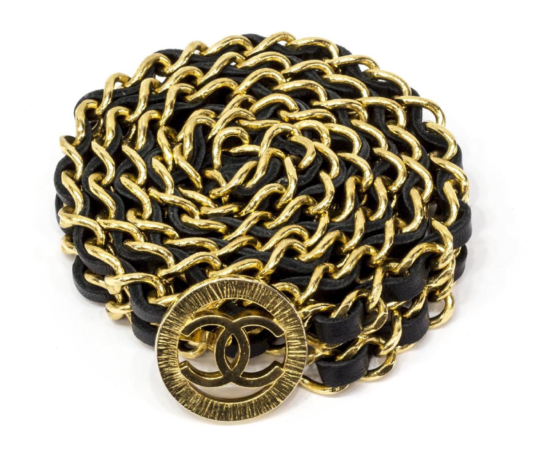 CHANEL BLACK LEATHER & GOLD TONE DOUBLE STRAP BELT: Chanel double strap chain belt, having gold tone hardware, black leather strap woven into links, having an interlocking CC logo to hook buckle, accompanied by box, 36.5"l *Provenance: Luxury goods are
