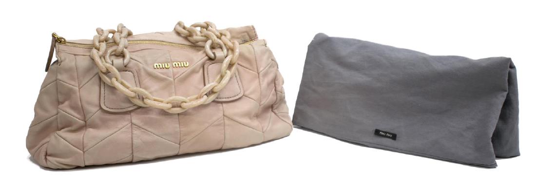 MIU MIU CHAIN HANDLE LIGHT PINK LEATHER HANDBAG: Miu Miu handbag in chevron pattern light pink leather, marbalized chain link handles above zipper top opening to lined interior with zippered pocket, some overall wear and discoloration, bag: approx 7