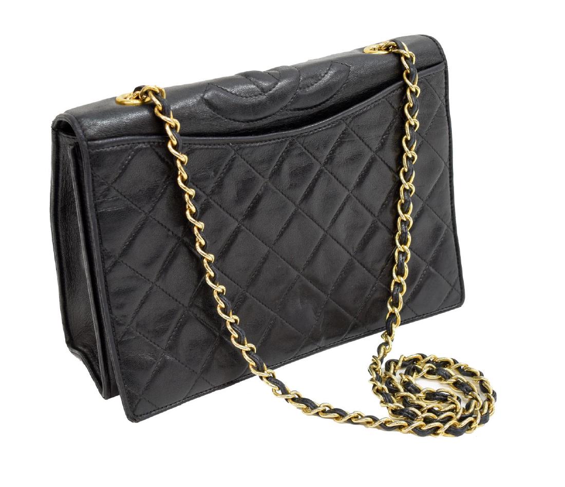 CHANEL FLAP TOP BLACK QUILTED LEATHER SHOULDER BAG: Chanel flap top shoulder bag in black quilted leather, gold tone hardware, slot pockets to either side, leather and chain shoulder strap above snap flap top, opening to lined interior with zippered po
