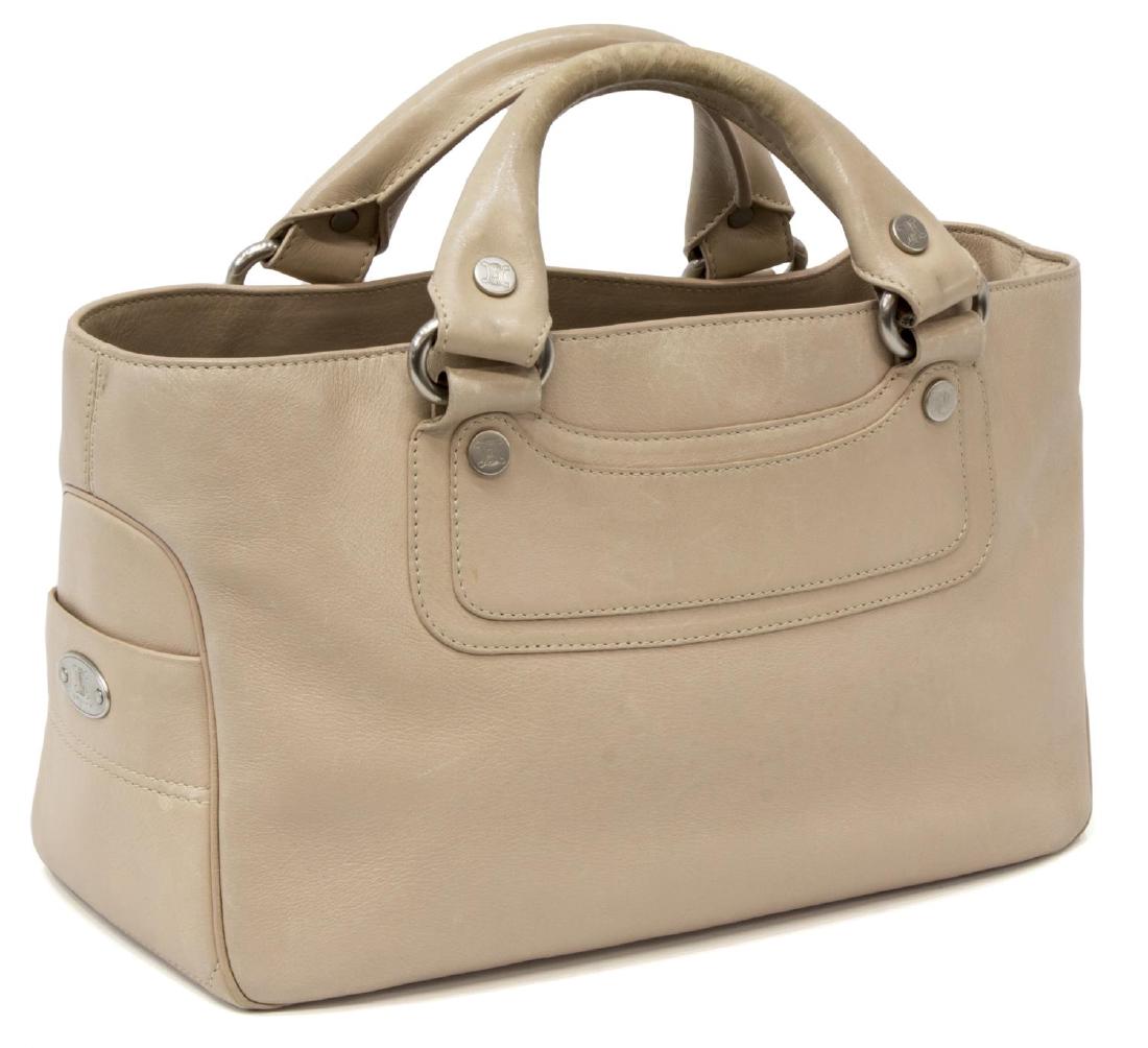 CELINE BEIGE LEATHER BOOGIE HANDBAG: Celine "Boogie" handbag in beige leather, dual leather handles and silver tone hardware, flanked exterior side slots, opening to brown fabric interior with a centered full length zipper pocket flanked