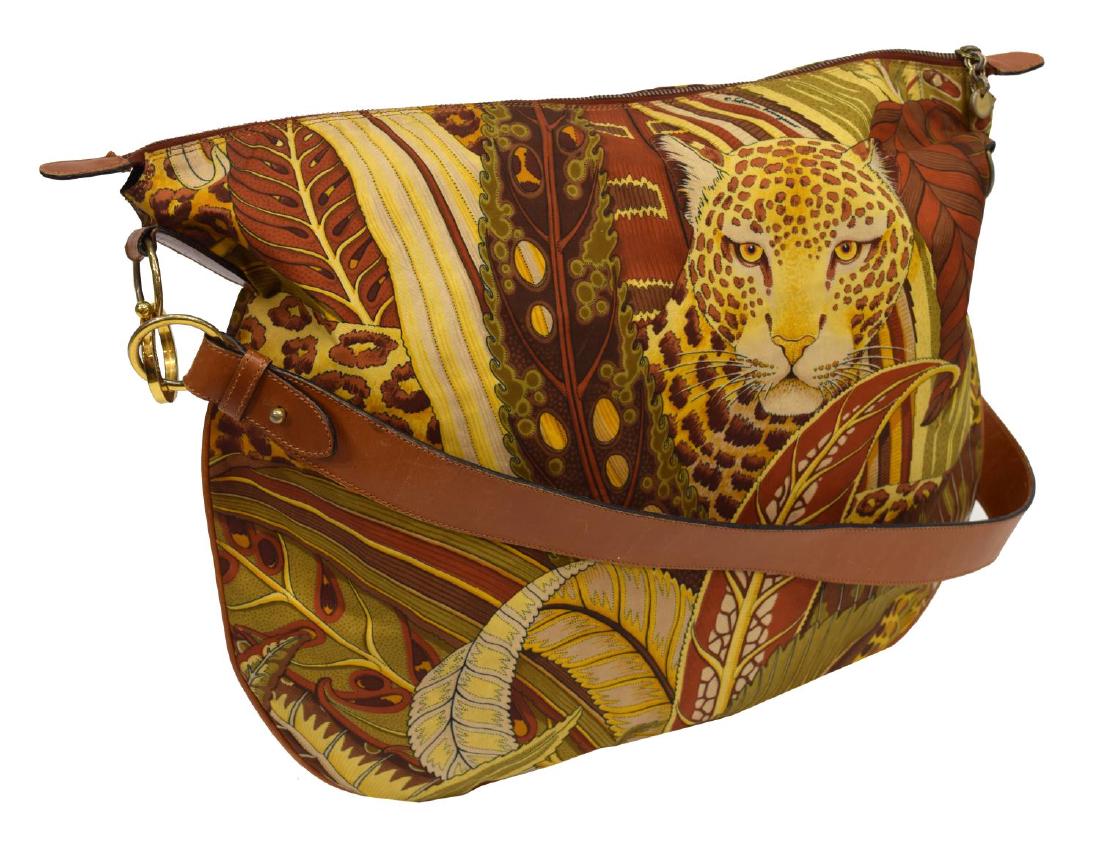 FERRAGAMO LEOPARD JUNGLE PRINT & LEATHER PURSE: Large Ferragamo shoulder bag having brown leather shoulder trap and gold tone hardware, leopard jungle print on the bag with zipper top, opening to logo black lined interior with zipper pocket, some c