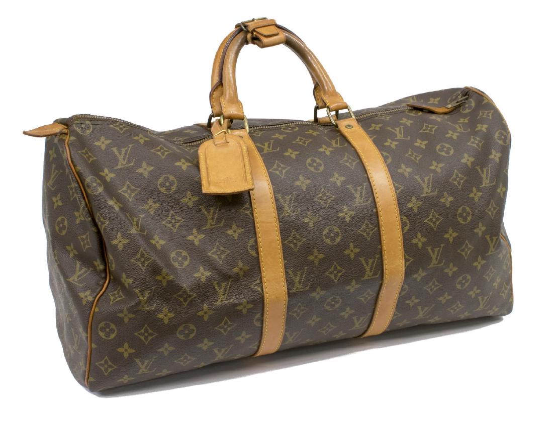 LOUIS VUITTON 'KEEPALL 55' MONOGRAM TRAVEL BAG: Louis Vuitton 'Keepall 55' travel duffel bag in brown monogram canvas, having leather handles, trim and piping, zippered top opening to brown canvas lined interior, retaining luggage tag, lock and key