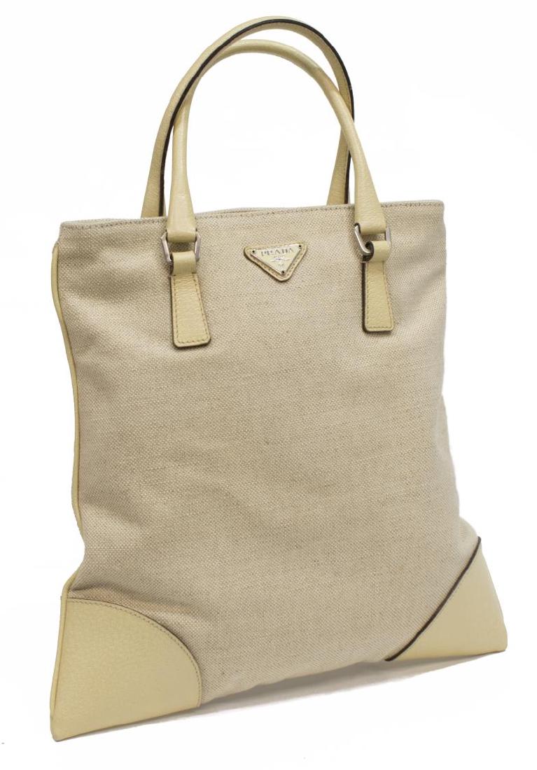 PRADA SMALL WOVEN JUTE AND LEATHER TOTE BAG: Prada small tote bag in woven jute/ hessian and cream leather, having silver tone hardware, exterior zipper pocket on reverse, double rolled leather handles and piping, zipper opening to Prada textile
