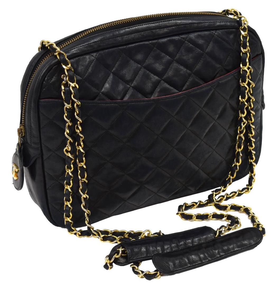 CHANEL QUILTED BLACK LEATHER ZIP SHOULDER BAG: Chanel shoulder bag in quilted black lambskin leather, gold tone hardware, dual chain link and leather shoulder straps, over zip top, opening to burgundy leather interior with zip and slot pockets, re