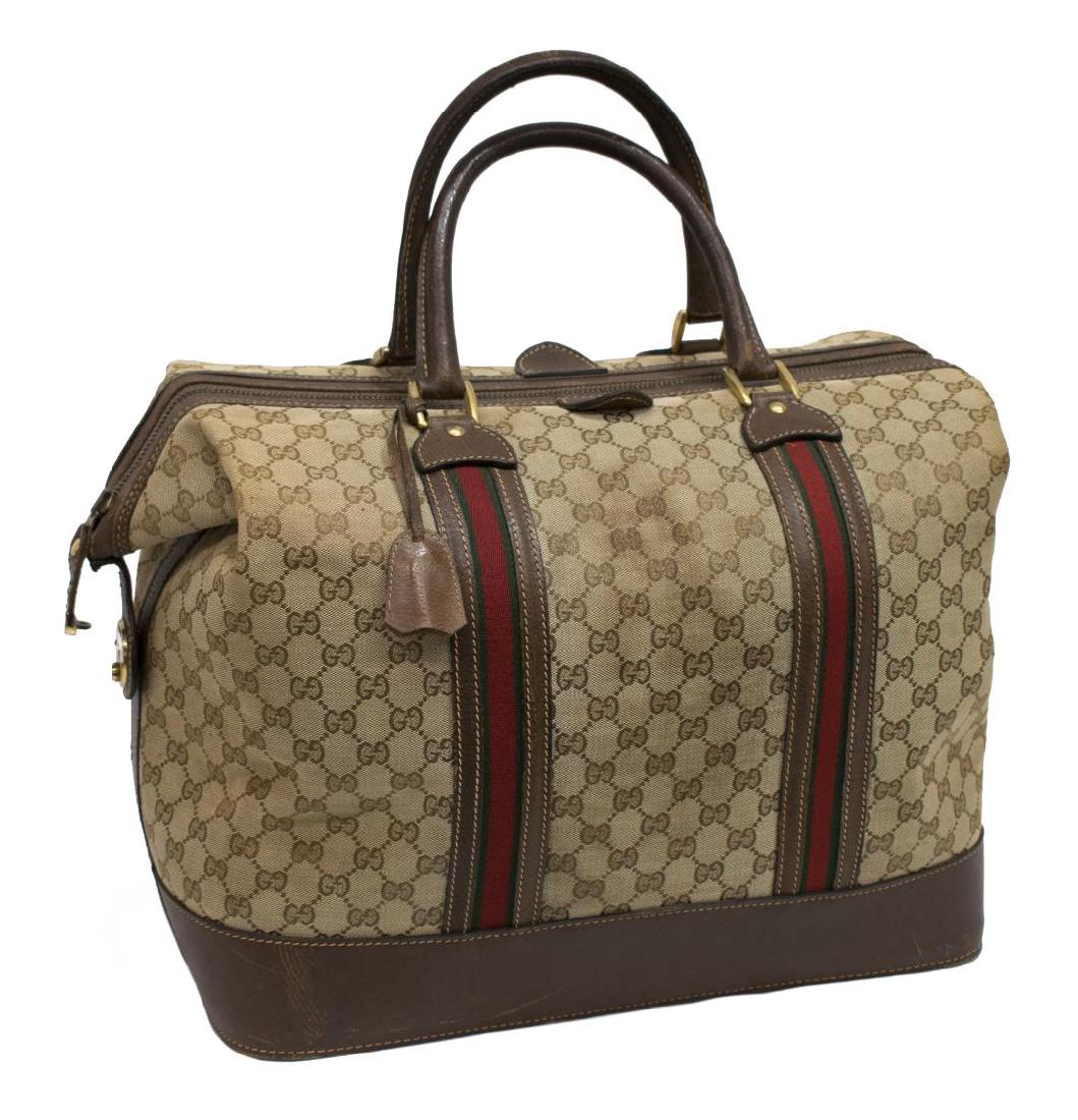 LARGE GUCCI MONOGRAM CANVAS DOCTOR BAG: Large Gucci doctor bag in monogram canvas, having gold tone hardware, leather trim and double rolled handles, rigid zipper opening to khaki lined interior, accompanied by certificate of authenticity, 