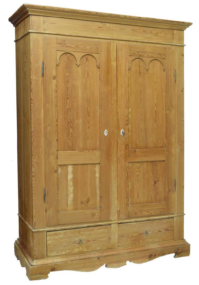 SCANDINAVIAN PINE WOOD DOUBLE-DOOR ARMOIRE: Scandinavian pine wood armoire, 20th c., having cornice top, over double doors, with gothic arch door panels and bone escutcheons, over two side-by-side drawers, shaped apron, rising on bracket feet, 