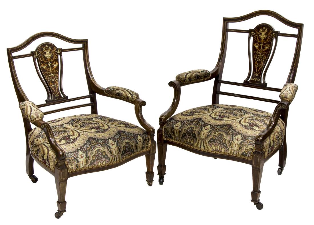 (2) EDWARDIAN BONE INLAID GENTS & LADIES CHAIRS: (lot of 2) Edwardian mahogany arm chairs, early 20th c., each with string inlay, an arched crest rail over the vasi form splat having foliate and bone inlay, floral pattern upholstery with padded arms