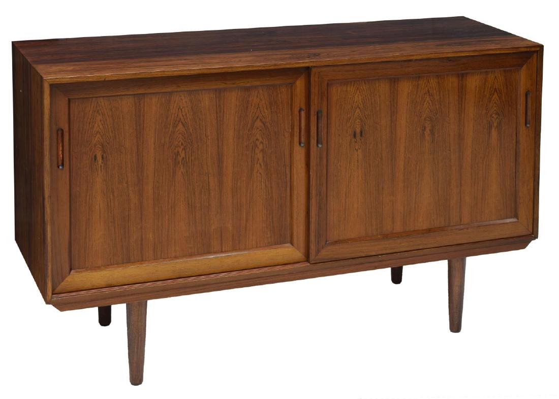 DANISH MID-CENTURY MODERN ROSEWOOD CABINET: Danish mid-century modern rosewood cabinet, c. 1960s, having rectangular cabinet, with two sliding doors, opening to shelved storage, rising on turned legs, approx 29"h, 45.75"w, 15.75"d Start Price: