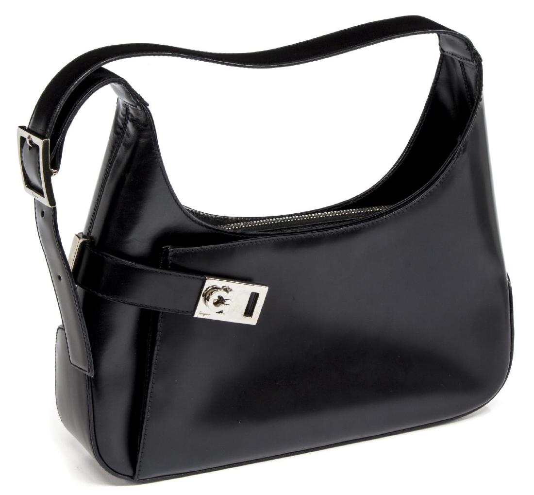 FERRAGAMO SMOOTH BLACK LEATHER SHOULDER BAG: Ferragamo smooth black leather hobo bag, having silver tone hardware, logo buckle top front, opens slim pocket, fronting zipper top, logo lined interior with slot pocket, adjustable shoulder strap, li
