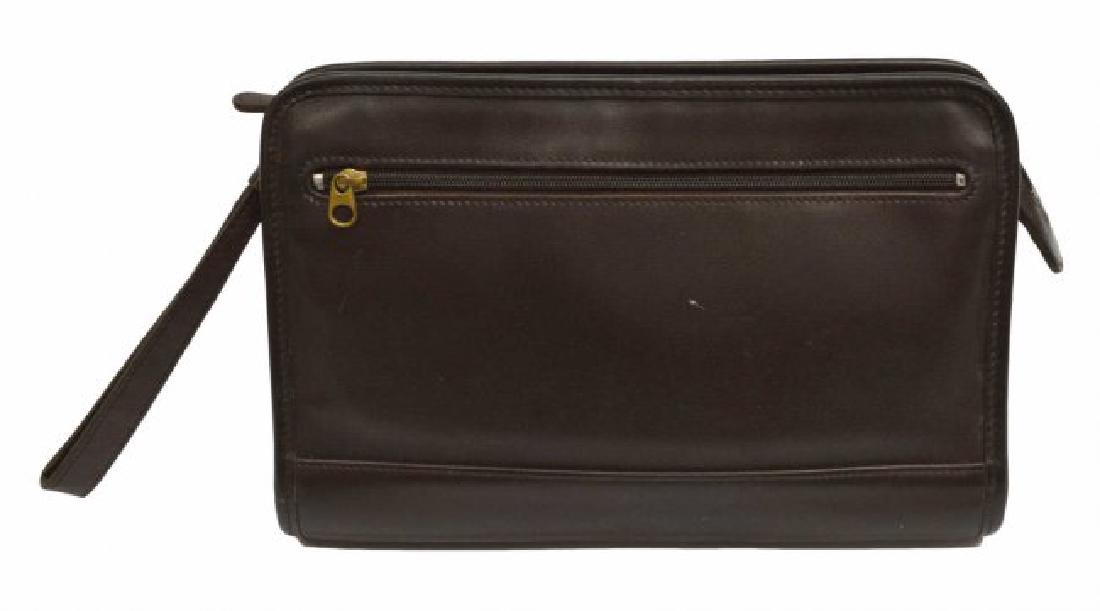 COACH BROWN LEATHER ACCESSORY POUCH OR CLUTCH: Coach brown leather pouch, black fabric interior having one zipper cell pocket, exterior with one zipper pocket, detachable leather strap, some small scratches to leather 7.5"h, 11"w, 2"d, 1lbs *Prove