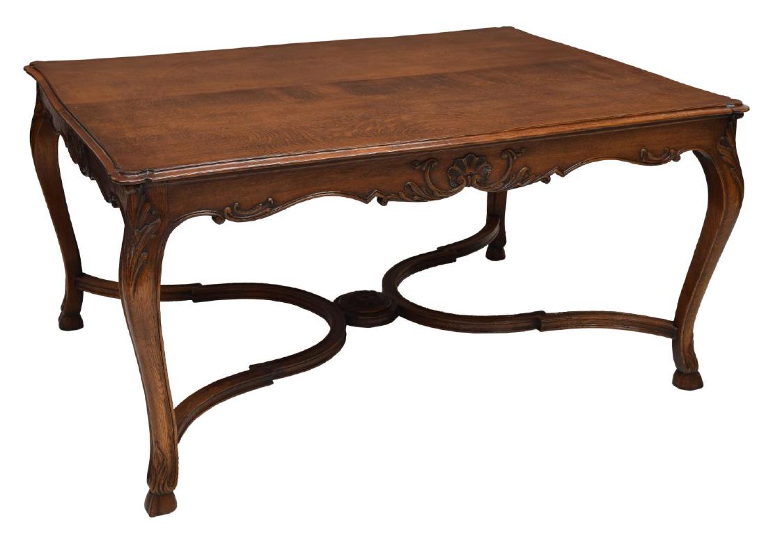 LOUIS XV STYLE SHELL & FOLIATE OAK DINING TABLE: Louis XV style oak dining table, the oversized top with shaped and molded border, over a shell and foliate carved apron, four cabriole legs joined by shaped stretchers, centered by a well defined flor