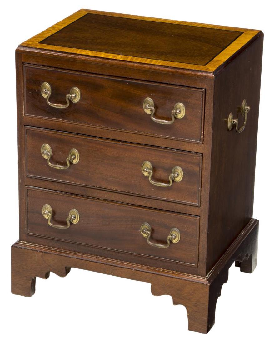 GEORGIAN STYLE BANDED MAHOGANY SIDE CABINET: Diminutive mahogany side cabinet, having banded top over three drawers, on a bracket base, some wear to top, approx 22"h, 16.5"w, 12.75"d **Provenance: The living estate of Coach George Hannon (Kemp, 
