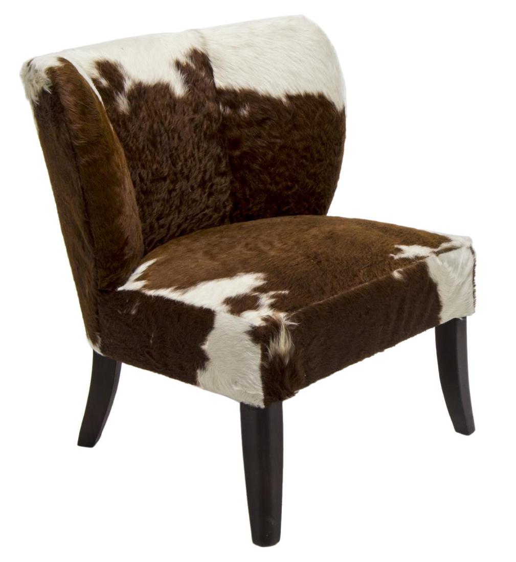 MODERN BROWN & WHITE COWHIDE CHAIR: Modern chair in brown and white cowhide upholstery, the curved back and seat rising on black squared tapered legs, 34"h, 31"w, 26"d Start Price: $150.00