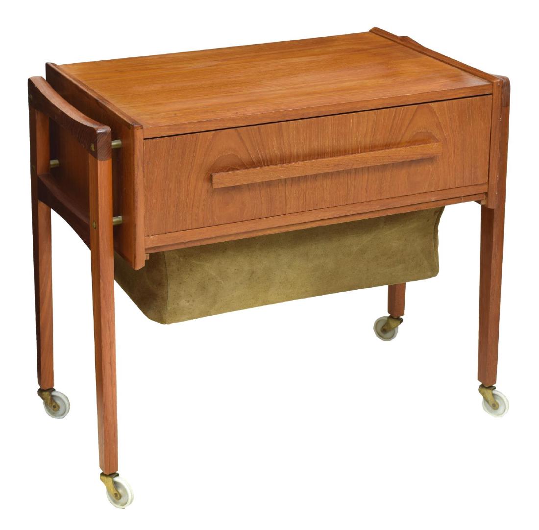 DANISH MID-CENTURY MODERN TEAK SEWING TASK TABLE: Danish mid-century modern teakwood sewing or task table, c. 1950s, rectangular top, with single drawer, over pull-out tray with fabric basket, rising on square legs and casters, approx 24.25"h, 28"w, 
