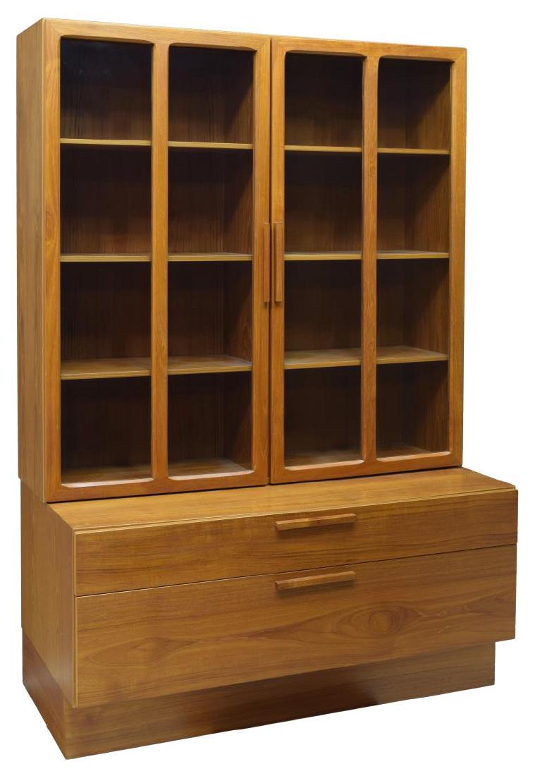 DANISH MODERN IB KOFOD LARSEN FAARUP TEAK BOOKCASE: Danish mid-century modern teakwood bookcase, c. 1960, designed by Ib Kofod Larsen for Faarup Mobelfabrik, having double door cabinet, with glass inset doors, opening to shelves, over cabinet fitted wi