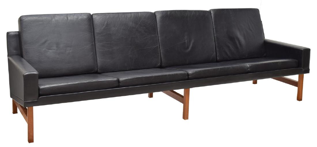 DANISH MID-CENTURY MODERN FOUR SEAT LEATHER SOFA: Danish mid-century modern teakwood framed sofa, c. 1960, the eight back and seat cushions upholstered in black leather, 33"h, 103"w, 29"d Start Price: $600.00