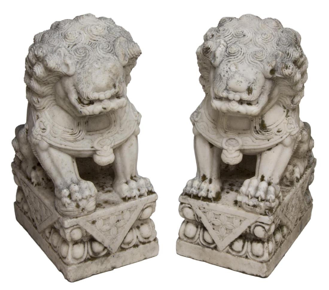 (2) LARGE CHINESE WELL CARVED MARBLE FOO LIONS: (pair) Large Chinese carved marble guardian foo lions, each with tightly curled mane in a seated pose, upon well carved pedestal base, some staining, chips, approx 21.5"h, 8.25"w, 12"l **Provenance: T