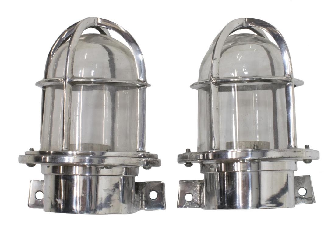 (2) INDUSTRIAL STYLE ALUMINUM CAGED WALL SCONCES: (lot of 2) Industrial style aluminum caged "ship's passage" wall sconces, modern, cage enclosing glass cover and single socket, in need of wiring, approx 6.5"h, 5.5"w, 5.5"w, 2.75lbs