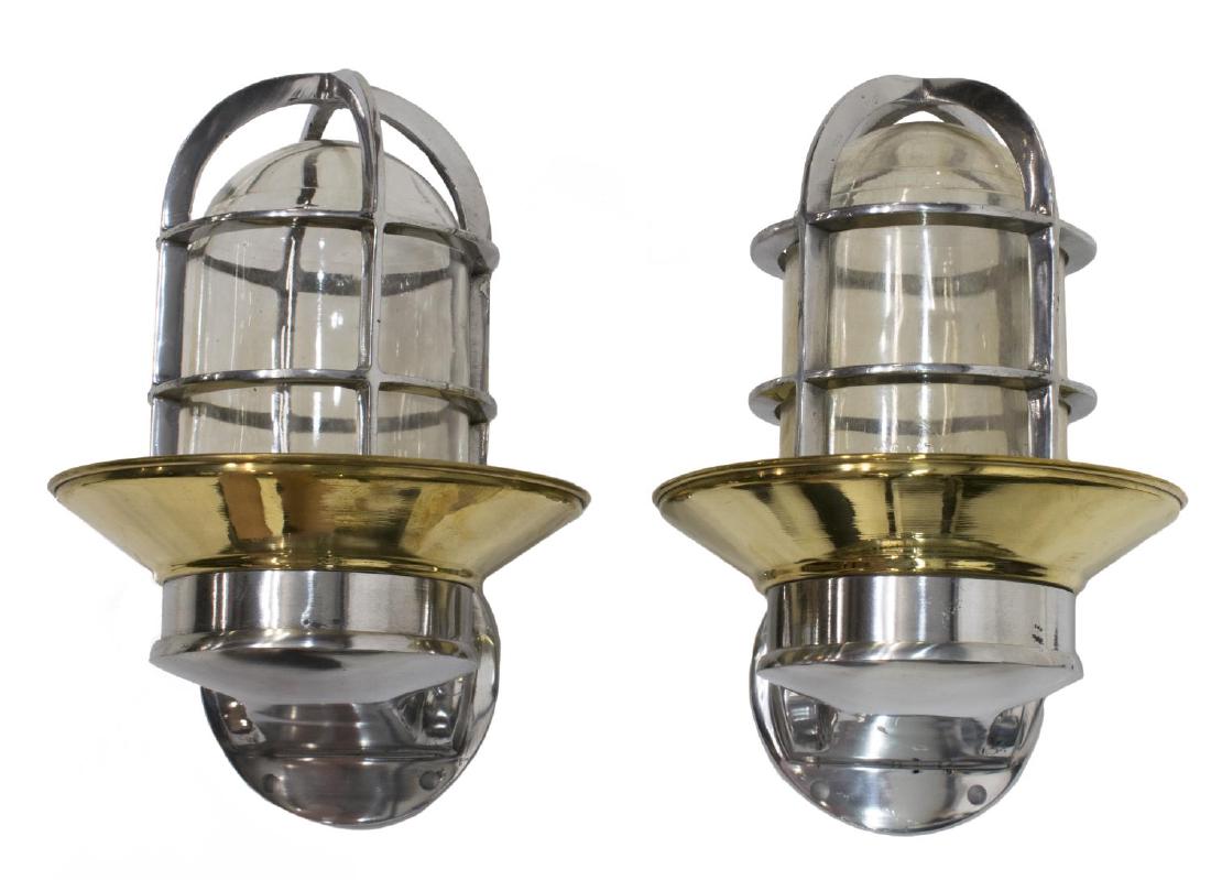 (2) INDUSTRIAL STYLE ALUMINUM & BRASS WALL LIGHTS: (lot of 2) Industrial style aluminum caged "ship's passage" wall LIGHTS, modern, a brass cover over each cage enclosing glass shade and single socket, in need of wiring, approx 9.5"h, 6"w, 7.5"d,
