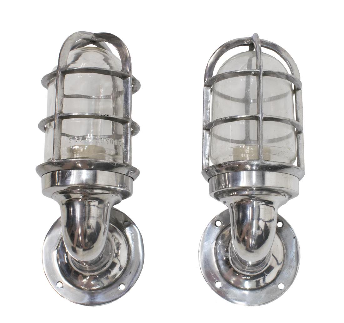 (2) INDUSTRIAL STYLE CAGED ALUMINUM WALL SCONCES: (lot of 2) Industrial style aluminum caged "ship's passage" wall sconces, modern, cage enclosing glass cover and single socket, in need of wiring, approx 11.5"l, 4.5"w, 5"d, 4.75lbs