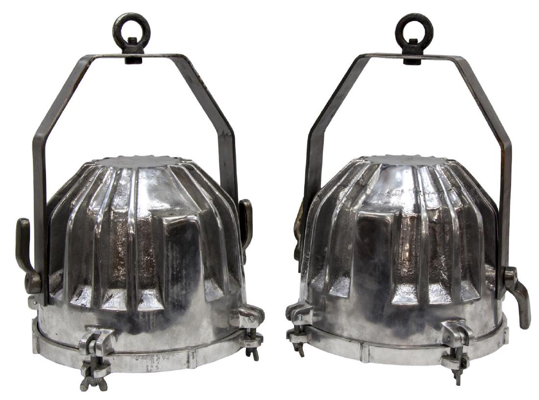 (2)INDUSTRIAL STYLE RIBBED ALUMINUM PENDANT LIGHTS: (pair) Industrial style ribbed aluminum pendant lights, each having swing arm over ribbed body, fitted with glass to bottom, lacking socket and wiring, in need of wiring, approx 18"h (to hanging loop)