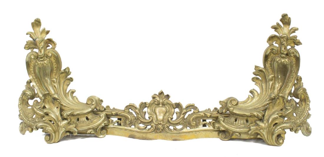(3) FRENCH GILT BRONZE CHENETS & FIRE FENDER: (lot of 4) French bronze fireplace chenets with fender, 19th c., having: (2) chenets, ornately pierced foliated scroll work, approx 14"h, 12"w, 8"d; (1) matching fender, stamped on back left support 4