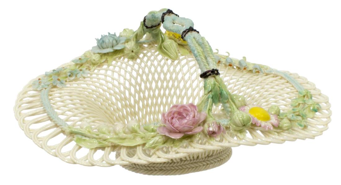 IRISH BELLEEK HENSHALL'S TWIG PORCELAIN BASKET: Irish Belleek woven porcelain four-strand 'Henshall's Twig' handled basket, having polychrome applied flowers and buds, impressed ribbon marks as pictured, likely 1955-1979, no chips or cracks noted,