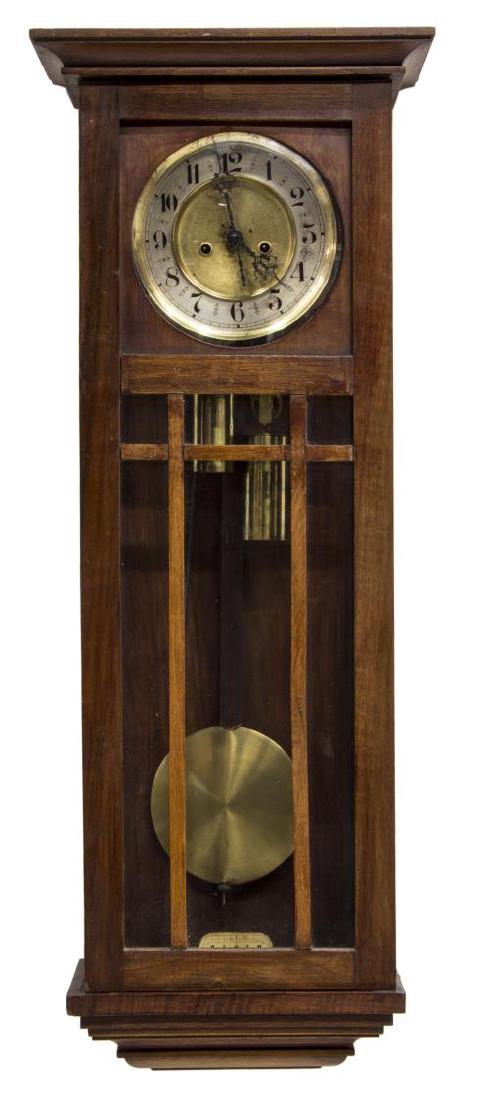 JUNGHANS TWO WEIGHT WALL CLOCK: German wall clock in the Arts & Crafts style, early 20th c., the two weight time and strike movement by Junghans, a mahogany case with glass front and sides, convex glass over the brass clock face wit