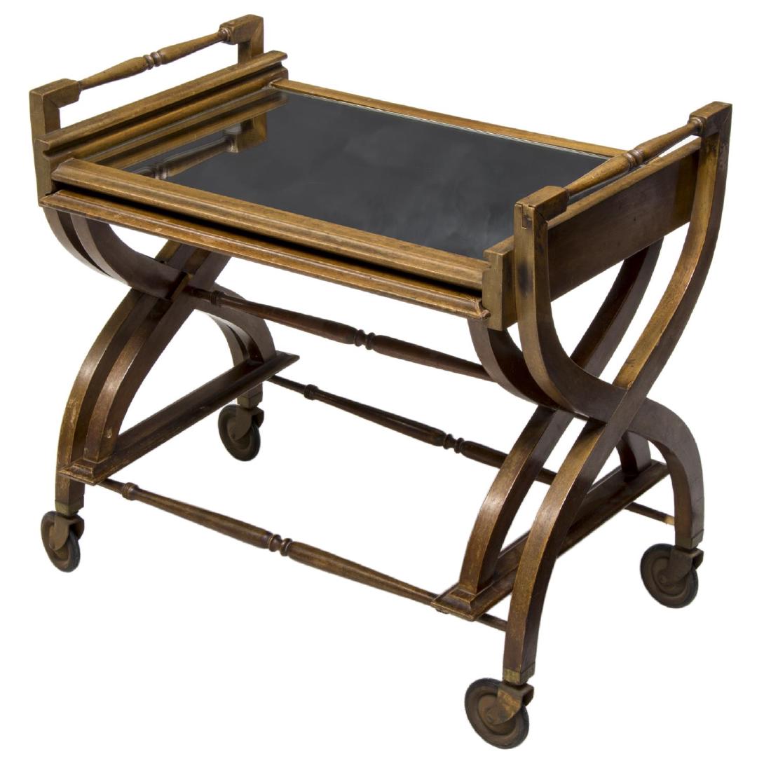 VINTAGE NESTING TABLE SERVICE CART: Vintage service cart, 20th c., having mirrored top, turned handles, nested tray table, x-form bracket base, joined by turned stretcher, all on casters, approx 24.25"h, 26"w, 16.25"d Start Price: $80.0