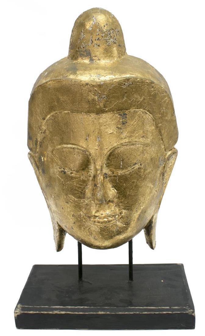 LARGE CARVED GILTWOOD FACE OF BUDDHA: Large carved giltwood face of Buddha, rising on two metal supports, on a square wooden base, approx. 23.75â€h, 13.75â€w, 8â€d, 11.25lbs Start Price: $80.00