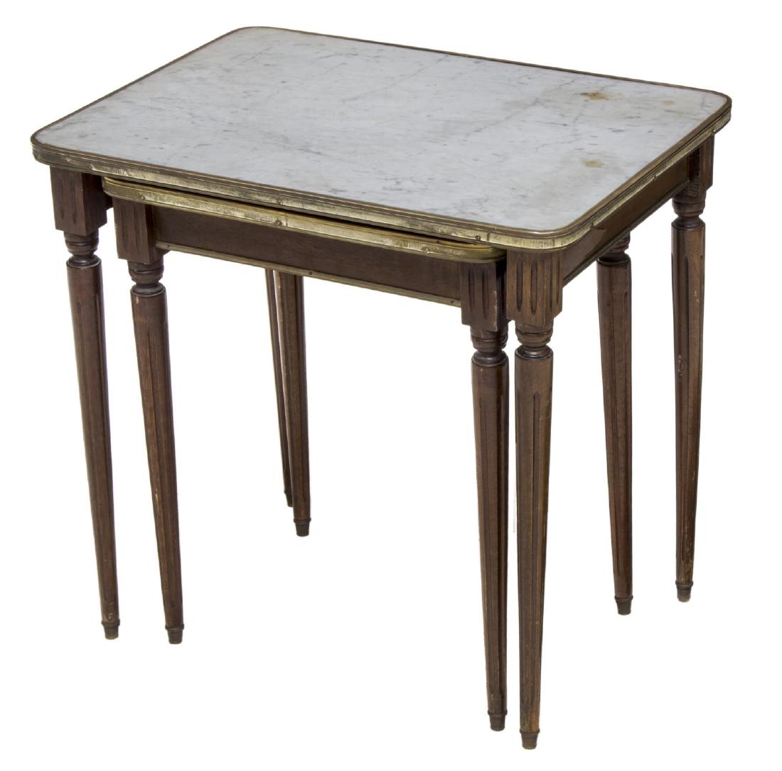 (2) LOUIS XVI STYLE MARBLE-TOP NESTING TABLES: (lot of 2) Louis XVI style nesting tables, Continental, 20th c., having marble tops, with metal trim, rising on fluted and tapered legs, largest: approx 20.75"h, 21.5"w, 15.5"d Start Price: $100.00