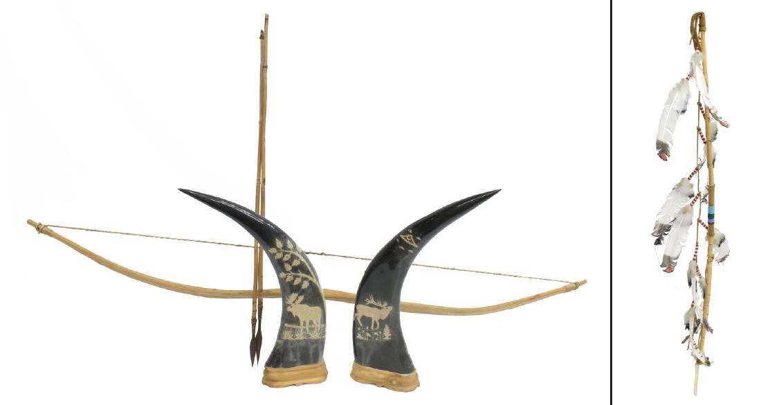 (4) CARVED BUFFALO HORN, NATIVE SPEAR, BOW & ARROW: (lot of 4) Decorative items, including: (2) carved buffalo horns, Canada, 20th c., depicting moose in natural landscape, presented on wood stands, originally purchased in Banff, Canada, approx 15.5"h,