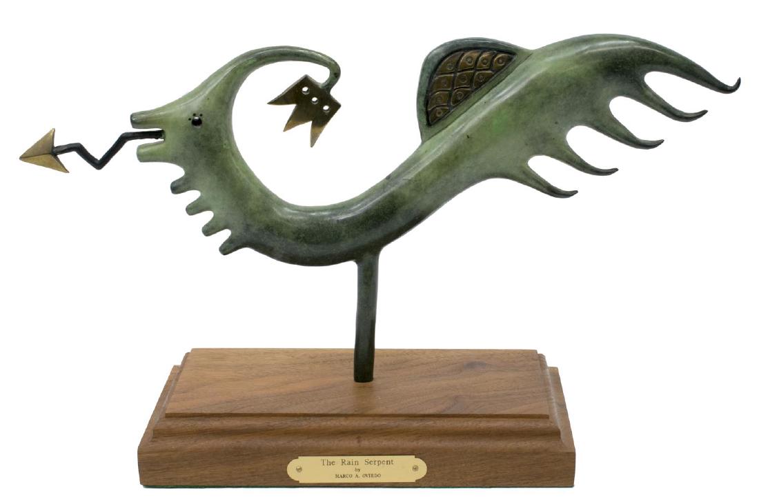 MARCO A. OVIEDO VERDE BRONZE, THE RAIN SERPENT: Verde and gilt patinated bronze, "The Rain Serpent" by Marco A. Oviedo (active New Mexico, 20thc.), rotating on a wood base, with brass artist and title tag, approx 10"h, 9.25"l, 5.25"w, 7lbs Start Pr
