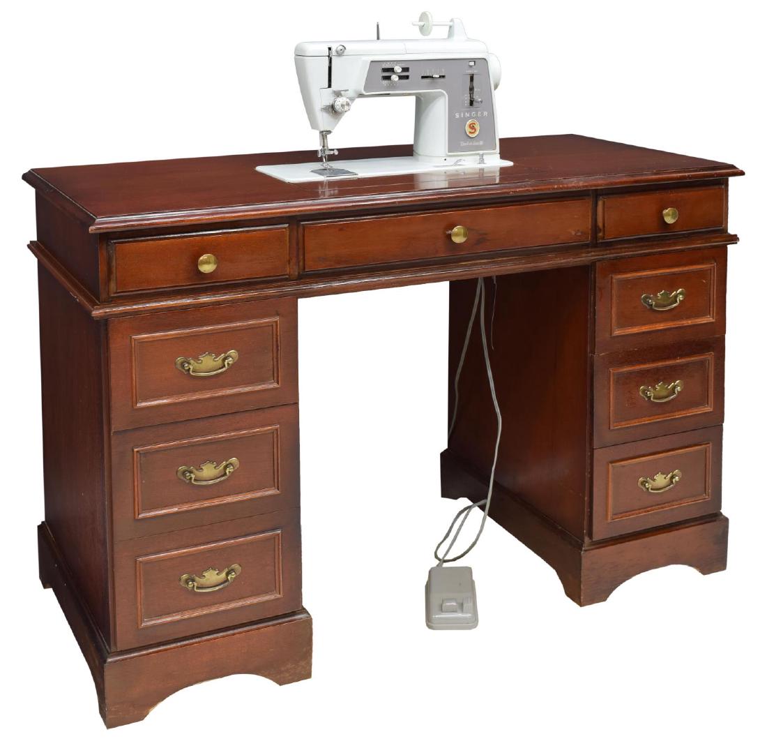 VINTAGE KNEEHOLE DESK WITH SINGER SEWING MACHINE: Vintage kneehole desk, case fitted with seven drawers, top concealing Singer Touch and Sew sewing machine, all rising on bracket feet, approx 30.5"h, 44"w, 22"d Start Price: $50.00