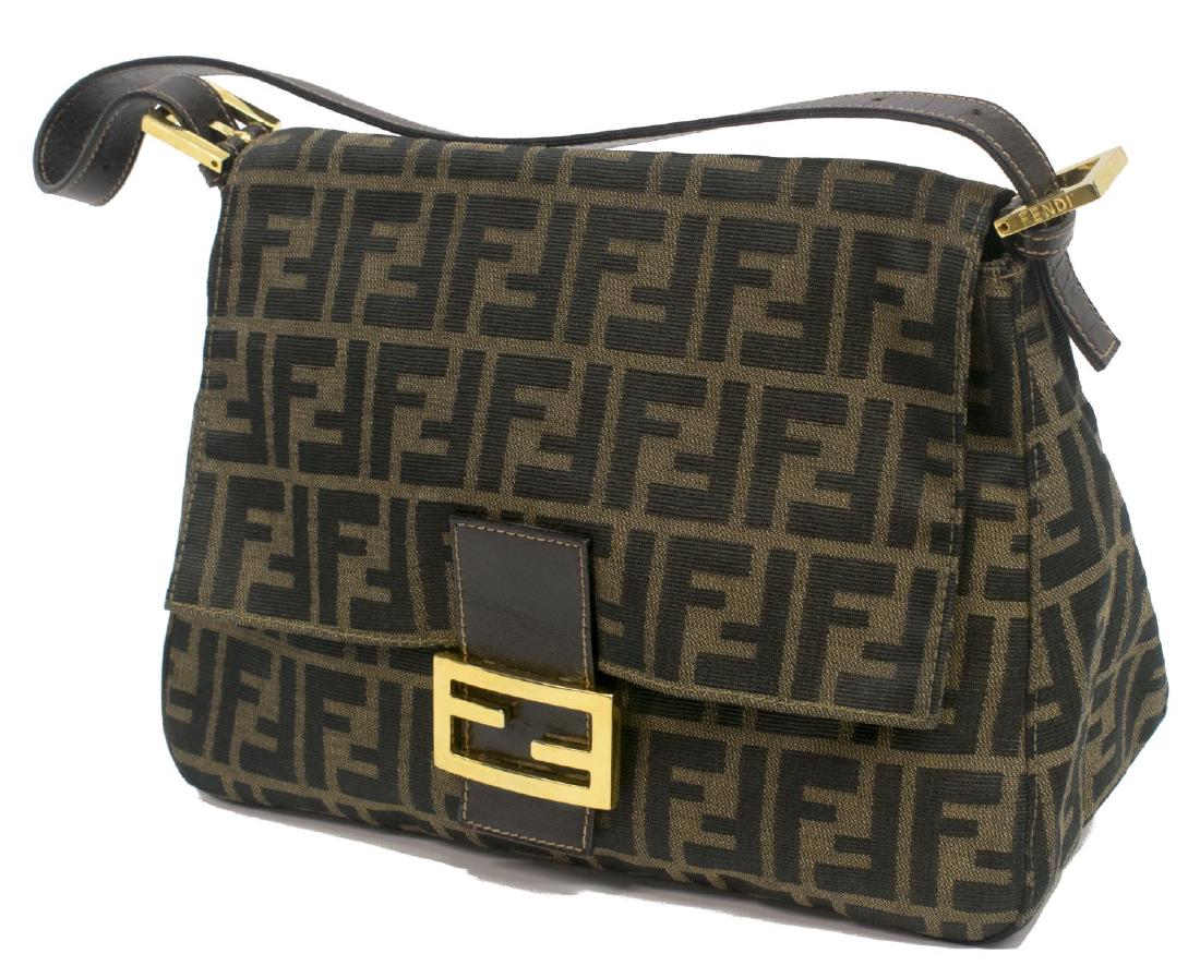 FENDI ZUCCA MONOGRAM CANVAS SHOULDER BAG: Fendi shoulder bag in brown Zucca monogrammed canvas, brown leather accents, gold tone hardware, magnetic snap closure opening flap to dark olive lined interior with single zip side pocket, adjustable