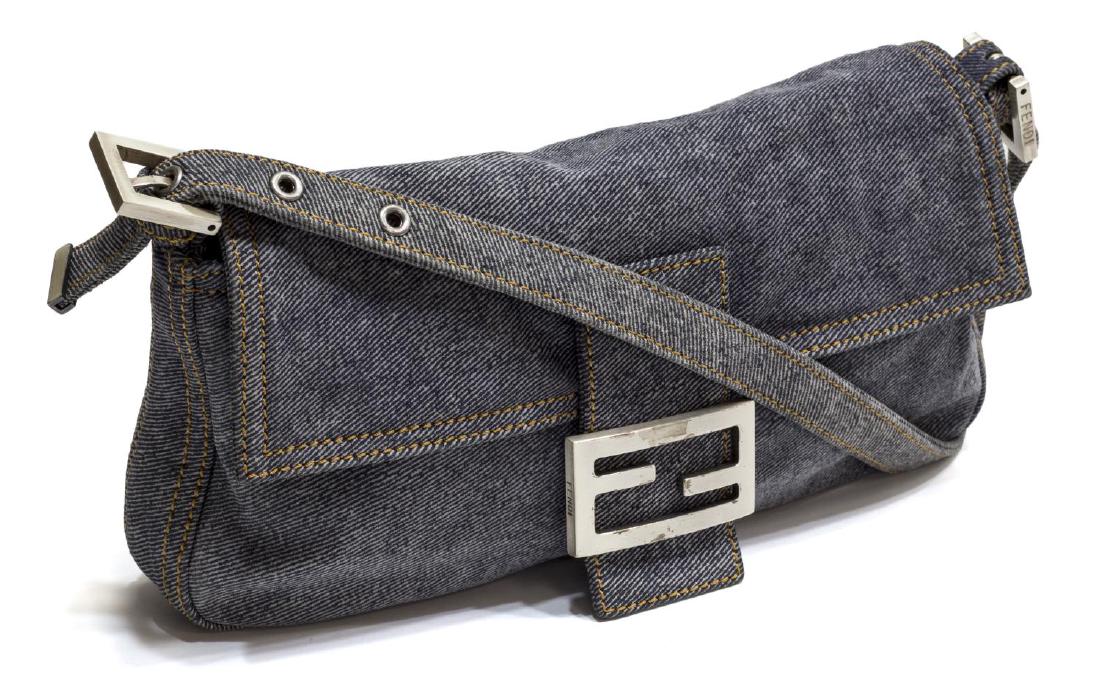 FENDI BAGUETTE BLUE DENIM CANVAS SHOULDER BAG: Fendi baguette light blue denim shoulder bag, having adjustable strap, snap closure with silver tone GG buckle, interior in dark blue canvas with single zip pocket, spots/patination to GG buckle, reta