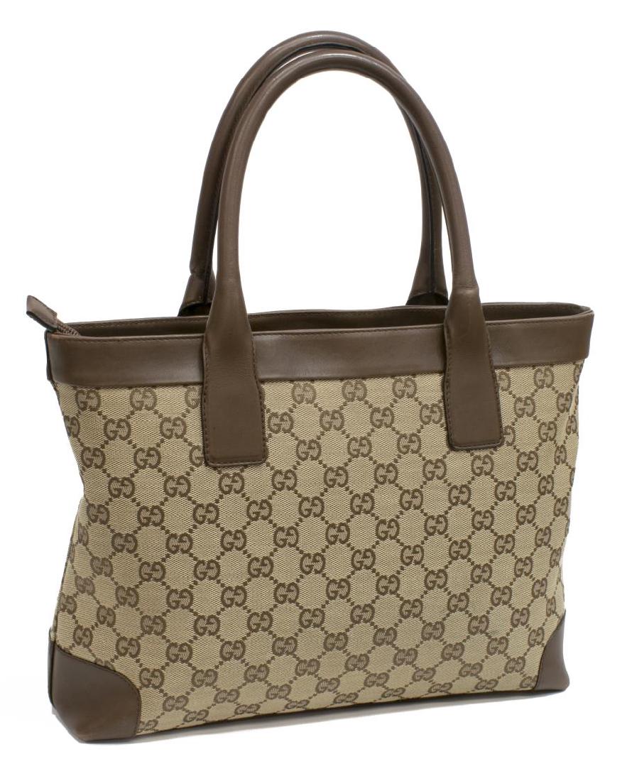GUCCI MONOGRAM CANVAS & BROWN LEATHER TOTE BAG: Gucci tote bag in tan monogram canvas, having brown leather trim and rolled double handles, over zip closure top, opening to fabric lined interior with single zipper pocket, some scuffing to leather c