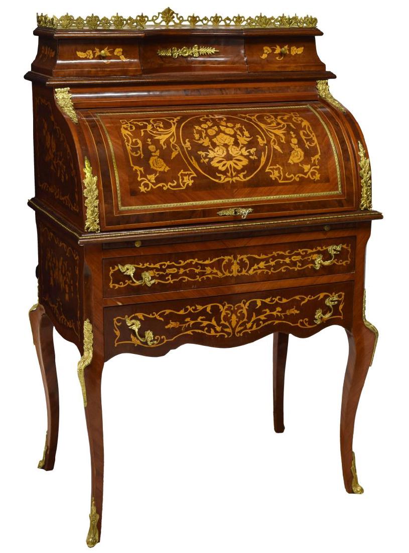 FRENCH MARQUETRY CYLINDER ROLL BUREAU: French marquetry and ormolu accented cylinder bureau, a pierced brass rail over two drawers above the cylinder roll opens to the writing surface and three drawer gallery, two lower exterior drawers, r