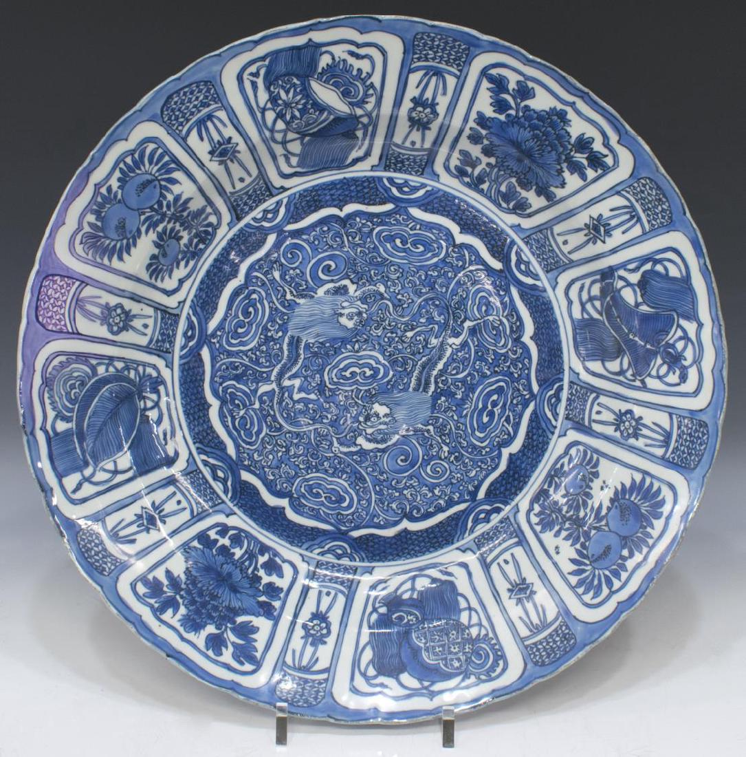 CHINESE BLUE WHITE KRAAK PORCELAIN DRAGON CHARGER: Chinese blue and white Kraak porcelain charger, possibly Ming dynasty (1368-1644), attributed to the Jingdezhen kilns, center depicting two dragons among clouds, blacklight examination revealing resto