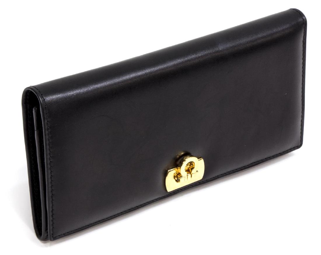 SALVATORE FERRAGAMO BLACK LEATHER WALLET: Salvatore Ferragamo long wallet in smooth black leather, having gold tone Gancio clasp opening to interior with cards slots, multiple bill slots and a zippered coin compartment, accompanied by box, bo