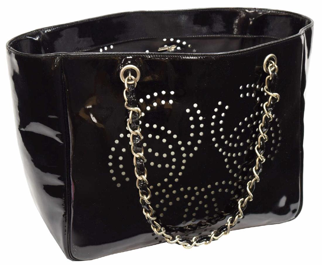 CHANEL BLACK PATENT PERFORATED CC TOTE BAG: Chanel tote bag, in black patent leather, with matte gunmetal hardware, dual vinyl woven chain-link shoulder straps, perforated CC accents throughout exterior, tonal lining, open top, accompanied by i