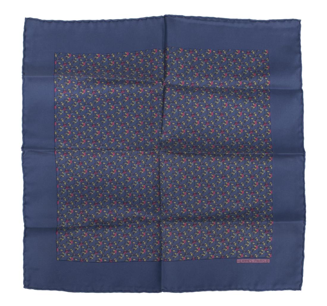 HEMES BLUE SILK MARIONETTE POCKET SQUARE: Hermes blue silk scarf / pocket square, the center with repeated flying marionette figures, marked to lower right, retaining care tag, approx 16 3/8"sq, .25lb *Provenance: Luxury goods are offered in